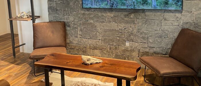 South Loft live-edge wood coffee table in a rustic lounge area.