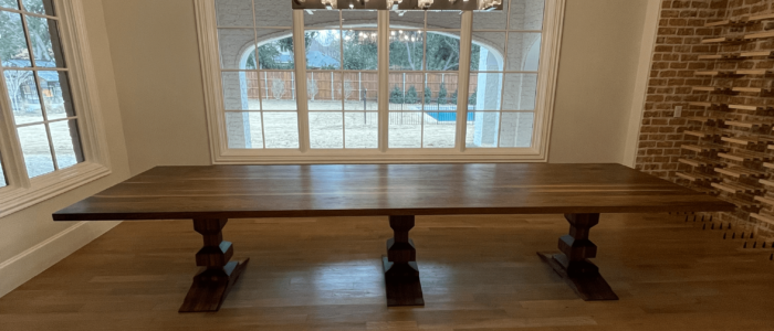 South Loft custom dark wood dining table placed in a well-lit dining room.